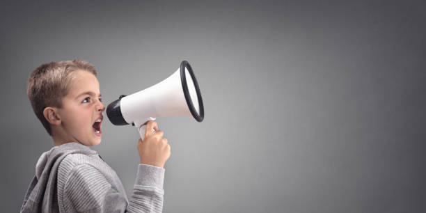 istock Boy with megaphone making an announcement 886661752