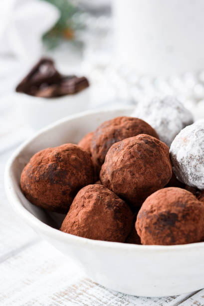 istock Chocolate truffles in white bowl on white table 886662286