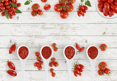 top view tomato sauce spoon with tomatoes isolated on kitchen white wooden table banner copy space template