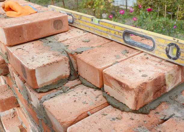 istock Bricklaying on House Construction Site with Spirit Level 886673666