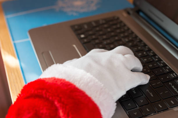 istock Santa Claus using laptop and typing on the keyboard 886676462