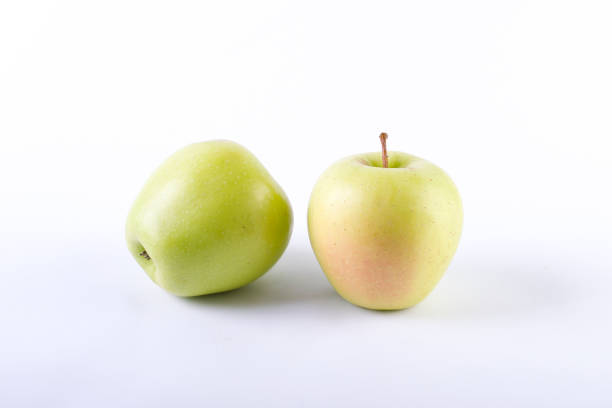 istock Fresh green apples on a white background. Two green apples on a white background. 886676546