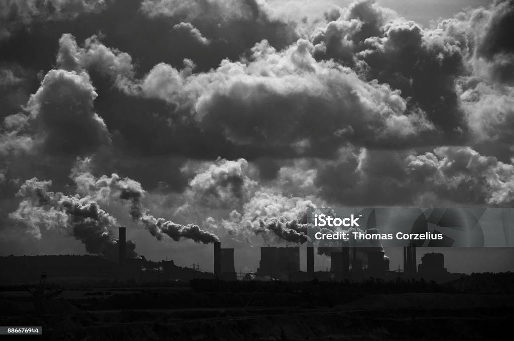 Lignite-fired power plants behind a brown coal mine with dramatic clouds and emissions These lignite-fired power plants are among the largest in Germany and Europe. They promote climate change through their CO2 emissions. They cause the highest greenhouse gas emissions of all European power plants. The particulate matter produced also contributes to environmental pollution. Business Finance and Industry Stock Photo