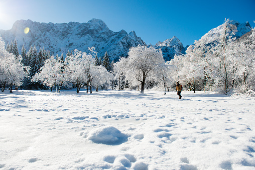 Senior man in the mountains in Winter. Lago di Fusine, Italy, Alps, Europe. All logos removed. Nikon.