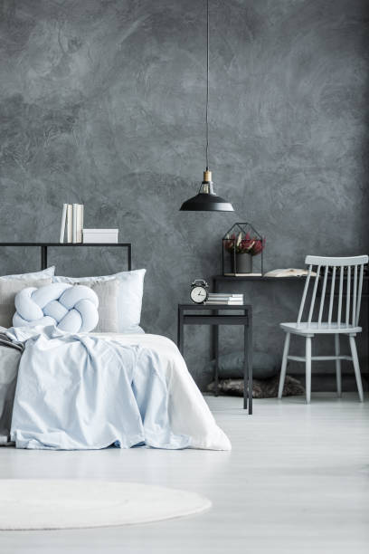 istock Black lamp in monochromatic bedroom 886680188