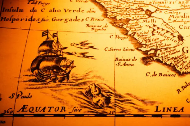 Detail from an old map showing a ship about to cross the equator, a sea monster and the coast of Africa. Map is from 1600 and is out of copyright.