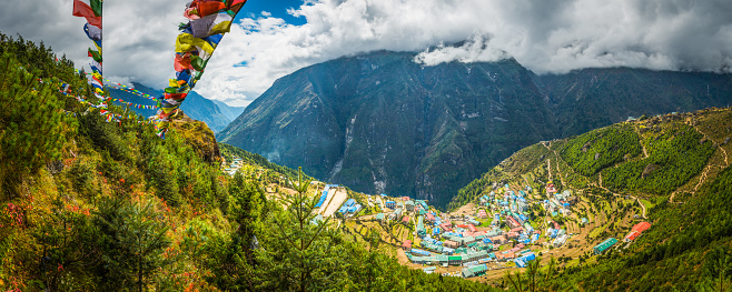 Colourful Buddhist prayer flags strung across the hillside above the natural amphitheatre of Namche Bazaar, the iconic Sherpa village and trading post high in the Himalaya mountains of Nepal.