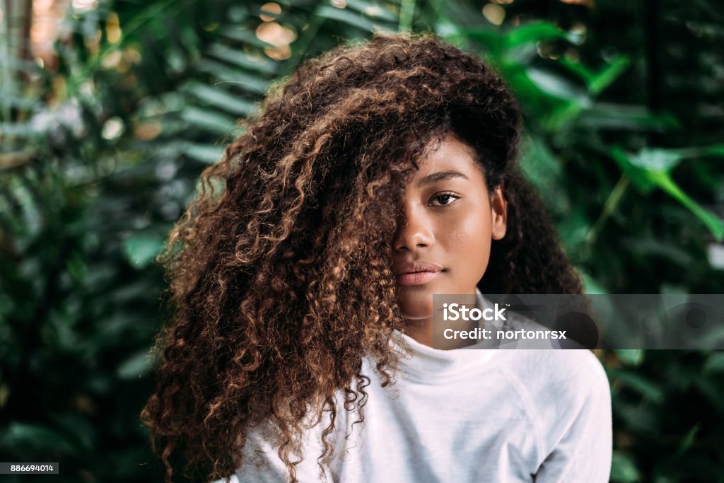 Beautiful dark skinned girl with curly hair. Curly Hair Stock Photo