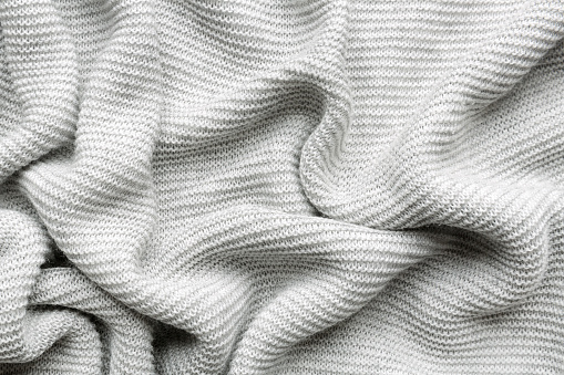 grey woolen knitted fabric as background
