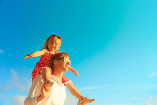 istock father and little daughter play at sky 886701858