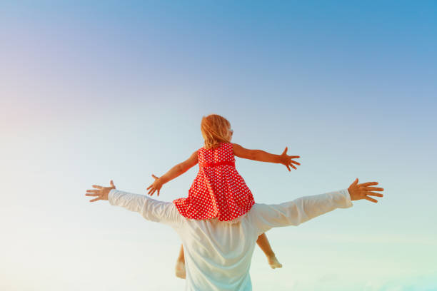 istock Father and little daughter play at sunset sky 886701910