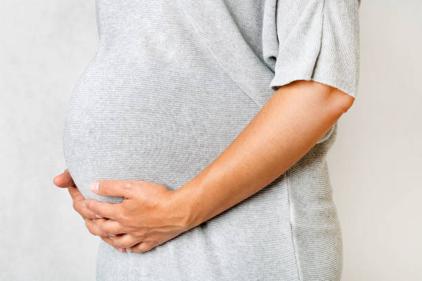 istock pregnant woman holding hands on her belly 886704592