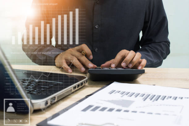 istock businessman working with business documents on wooden office table with computer notebook and calculator 886707440