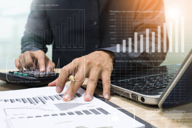 istock businessman working with business documents on wooden office table with computer notebook and calculator 886707456