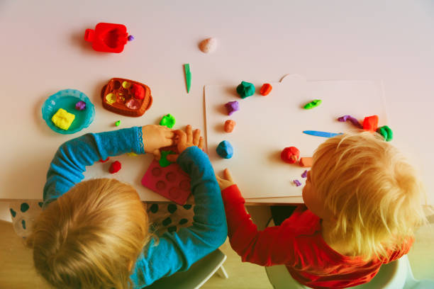 istock kids play with clay molding shapes 886707858