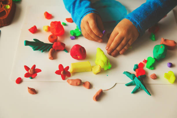 istock Child playing with clay molding shapes 886708012