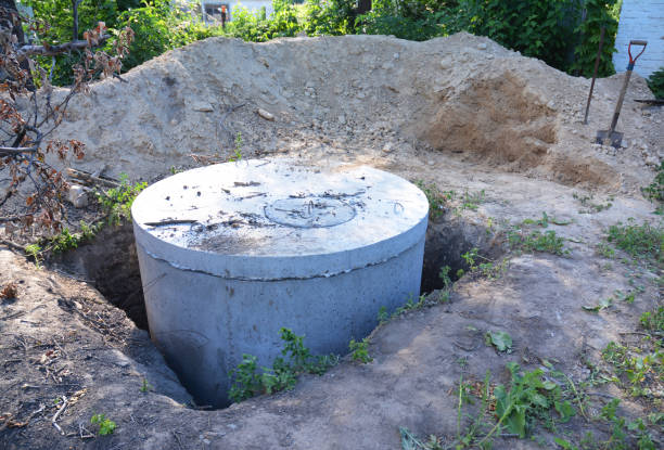 istock Manhole cover installation with sewer tank outdoors. 886708040