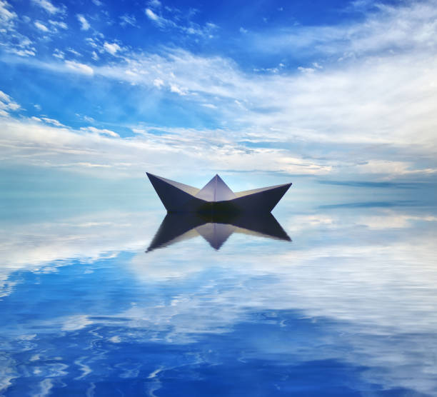 istock Paper boat on sea wave 886711386