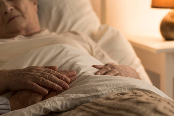Support during sickness Close-up of hand of senior on hand of dying elderly person as sign of support during sickness death stock pictures, royalty-free photos & images