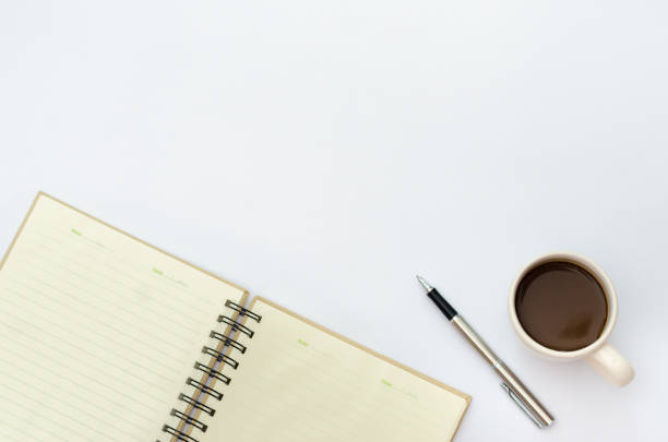 istock Space on the desk  Area space enter text. mockup coffee cups snack candy,  Pen note paper Placed on a White table top view desk table with a lot of things on it top view with copy space 886712406