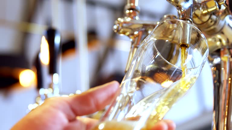 Brewer filling beer in beer glass from beer pump 4k