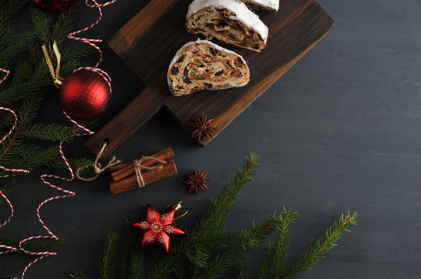 istock traditional Christmas cake with raisins and nuts with tree branches and toys 886719132