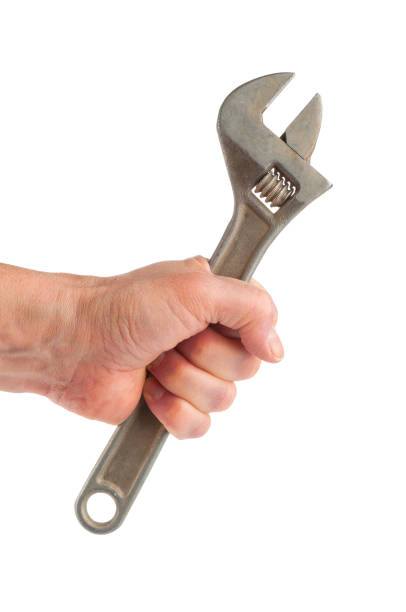 istock Hand holding wrench on white background 886755668