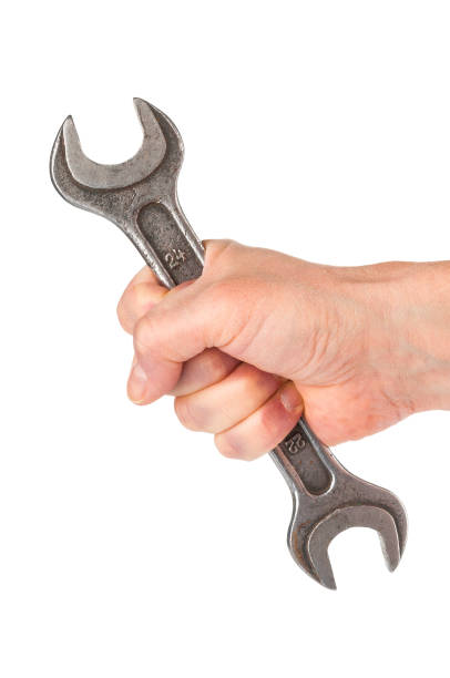 istock Wrench in hand closeup on white background 886761036
