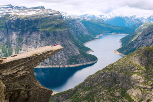 istock Sporty woman posing on Trolltunga Norway 886762088