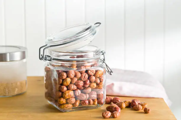 various sugared nuts in jar on kitchen table