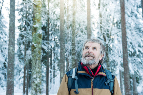 istock Senior Mountaineer in Alps, Winter Forest 886771618