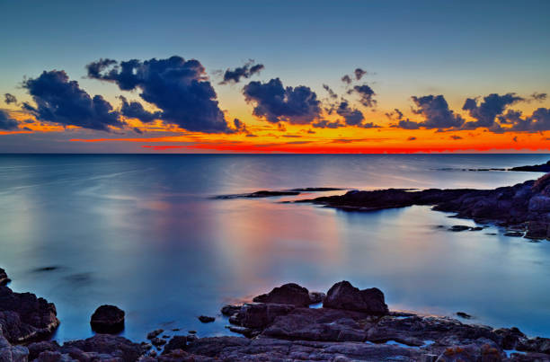 istock Sunrise on rocky shore and dramatic sky clouds 886776202