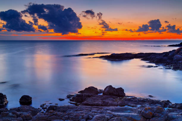 istock Sunrise on rocky shore and dramatic sky clouds 886776346