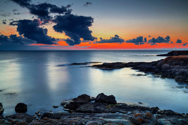 istock Sunrise on rocky shore and dramatic sky clouds 886776454