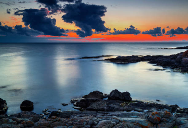 istock Sunrise on rocky shore and dramatic sky clouds 886776484