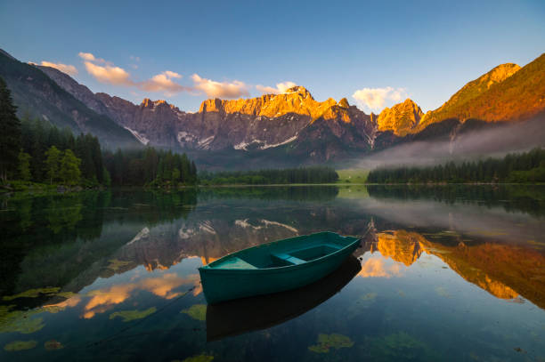 istock green boat on a mountain lake 886776656