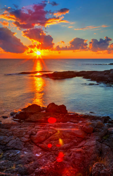 istock Sunrise on rocky shore and dramatic sky clouds 886776978