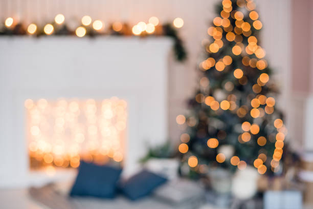 istock Blurred christmas background with fireplace and christmas tree 886785834
