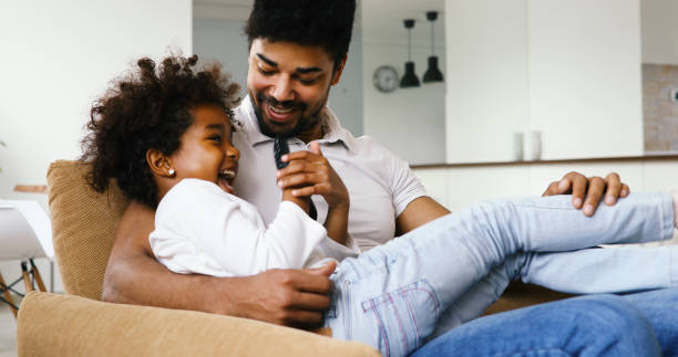 istock Father And Daughter Watching Television 886786464