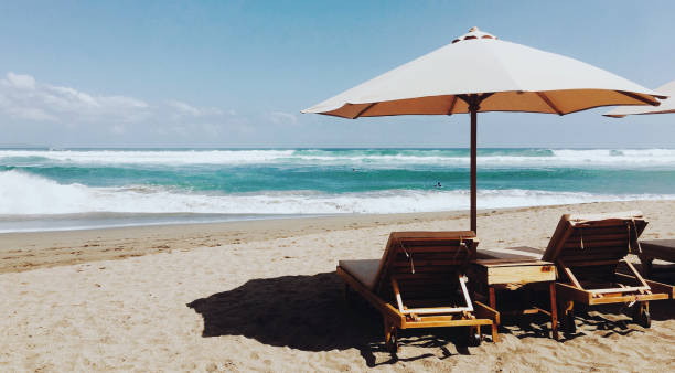 istock Cozy landscape of a beach with two loungers and umbrella between them 886791006