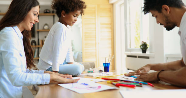 istock Mother and father drawing together with their child 886792166