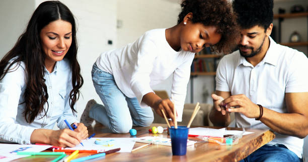 istock Mother and father drawing together with their child 886796574
