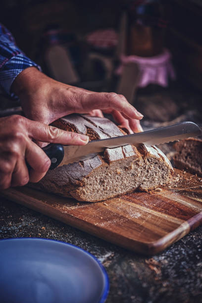 istock Cutting Fresh Homemade Brown Bread 886796918