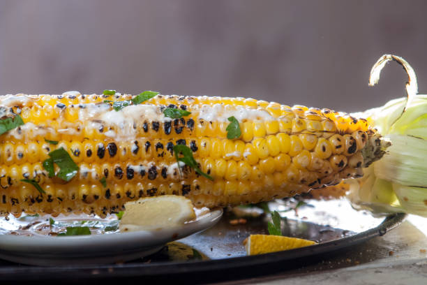 istock grilled corn on with lemon, herbs and spices 886797322
