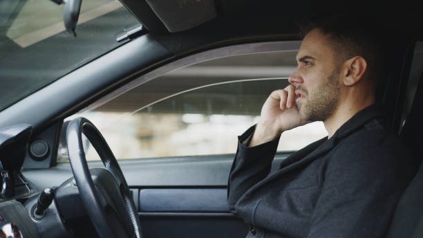 istock Stressed businessman swearing and talking phone while sitting inside car outdoors 886800734