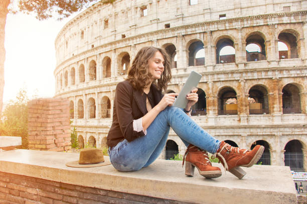istock Smiling woman in front of Colosseum 886800944