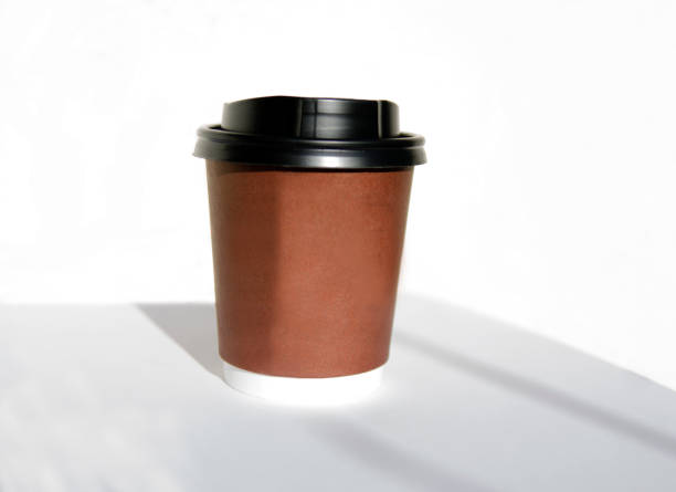 istock One brown coffe to go cup, small portable container for hot drink. Biodegradable ecologic coffe cup isolated on white. 886830042