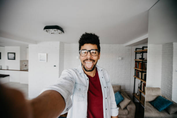 istock Goofy man taking selfie with his tongue out 886840824