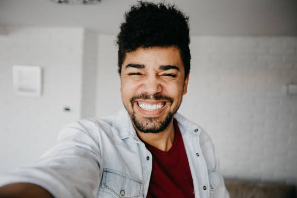 istock Happy african ethnicity man taking selfie at the apartment 886840828