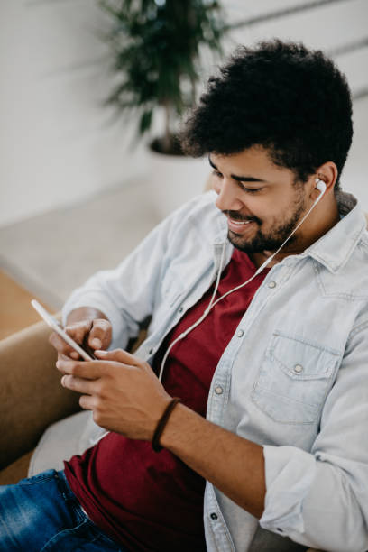 istock Smiling man is using smart phone for videochat with his family 886841098